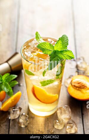 Summer peach mojito cocktail with fresh mint, lime and peach slices Stock Photo