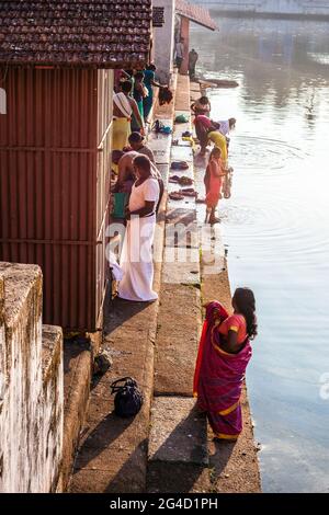 Indian worshippers performing their daily ablutions at the spiritual, holy sacred Koti Tirtha water tank at Gokarna, Karnataka, India Stock Photo