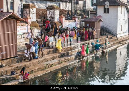 Indian worshippers performing their daily ablutions at the spiritual, holy sacred Koti Tirtha water tank at Gokarna, Karnataka, India Stock Photo