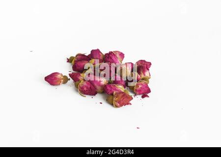 Dried pink rose buds on isolated white background Stock Photo
