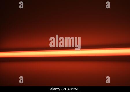 Orange LED bar on a wall Stock Photo