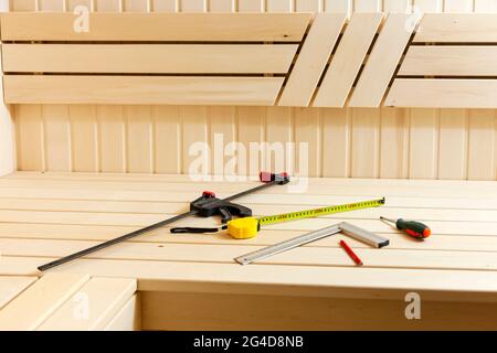 Sauna construction in progress. Wooden walls and benches Stock Photo