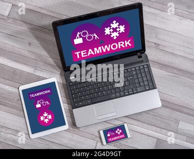 Teamwork concept shown on different information technology devices Stock Photo