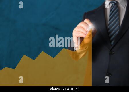 Manager drawing a chart or graph with a marker, smbolizing growing trend of stock value, shares, revenue or customer orders Stock Photo