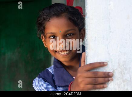 Close-up portrait of a rural school girl Catching a wall Stock Photo