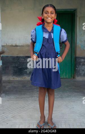 An Indian Rural School Girl wearing School Uniform Standing in school Stock Photo