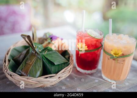 Thai drinks with traditional dessert of steamed sticky rice. Stock Photo