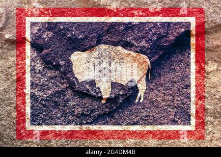 Aded Wyoming state flag icon pattern isolated on weathered solid rock wall background Stock Photo