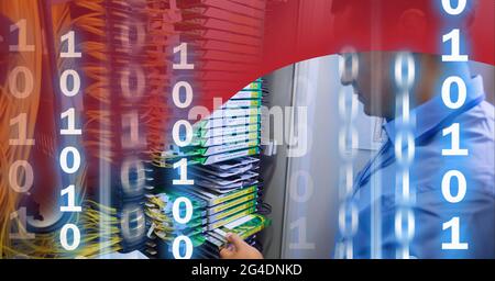 Binary coding data processing over man working in server room against red technology background Stock Photo