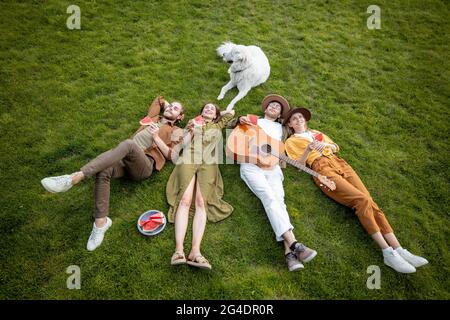 Friends lying together on the green lawn Stock Photo