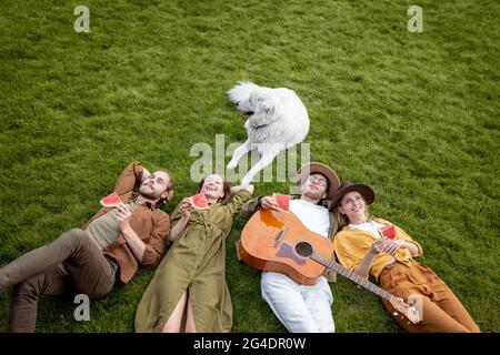 Friends lying together on the green lawn Stock Photo