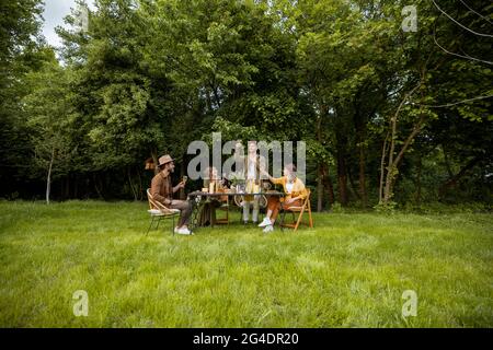 Friends having a festive dinner in nature Stock Photo