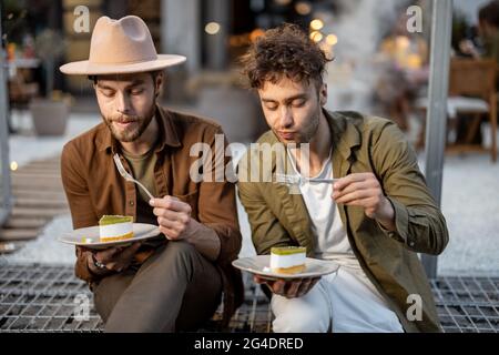 Two male friends talking on a porch of the country house Stock Photo