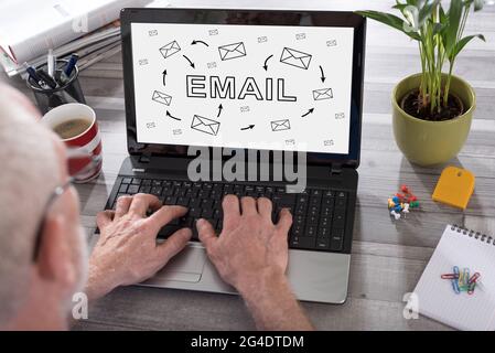 Email concept shown on a laptop used by a man Stock Photo