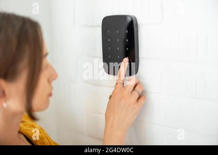 Entering code on the wireless alarm keyboard Stock Photo