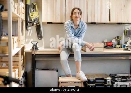 Handywoman in the home workshop Stock Photo