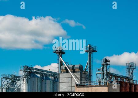 Modern granary over sky background. Warehouse of wheat and other cereals. Stock Photo