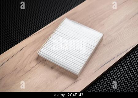 a new square white car air filter for cabin flat lay on dark background Stock Photo