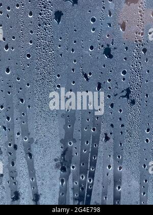 Dark drops of water on the sweaty glass. Background. Stock Photo