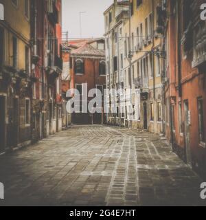 Small square in Venice without any people during italian lockdown crisis COVID-19, Italy. Vintage filtered Stock Photo