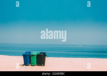 Three Colorful Plastic Waste Containers On Wheels For Separate Collection Of Garbage. Containers For Temporarily Storing Waste. Dustbins, Garbage Cans Stock Photo