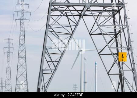 Group of Dutch electricity towers and wind turbine in Zutphen, The Netherlands Stock Photo
