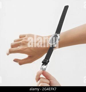 Men watch floating over the twist, modern minimalist conceptual advertising Stock Photo