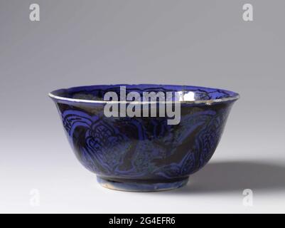 . Come from quartz frying goods decorated with a medallion divided into six compartments and floral motifs in brown luster on blue surface covered with transparent glaze. Stock Photo