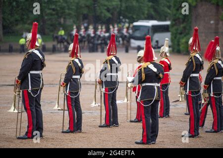 Horse Guards Parade, London, UK. 21 June 2021. The day of the summer solstice begins in London with cool temperatures and heavy rain as troops of the Household Cavalry take part in the Waterloo Eagle Parade on a rain soaked Horse Guards Parade ground. Credit: Malcolm Park/Alamy Live News Stock Photo