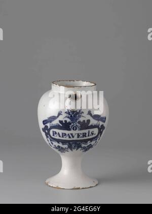 . Pharmacist spot from faience. With ear and spout and blue painted label with inscription: o / poppassis. Stock Photo