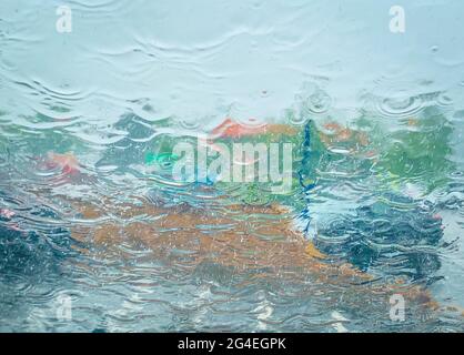Abstract Image of Torrential Rain Falling on Car Windscreen on a Summer Morning in June in Essex, UK Stock Photo