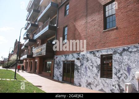 Downtown Lynchburg, VA, USA. Industrial complex repurposed as an apartment building , with commercial spaces at the main level. Stock Photo