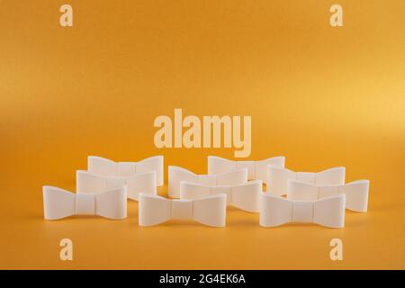 White paper ribbons on gold background. Composition with copy space. Stock Photo