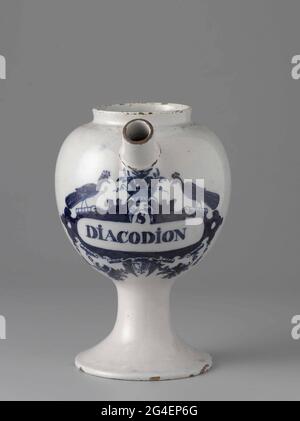. Pharmacist spot from faience. With ear and spout and blue painted label with inscription: S / Diacodion Stock Photo