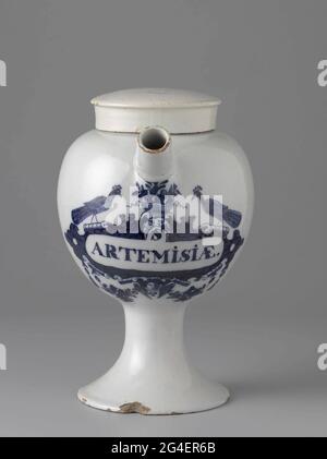 . Pharmacist spot from faience. With ear and spout and blue painted label with inscription: S / Artemisiae. Stock Photo