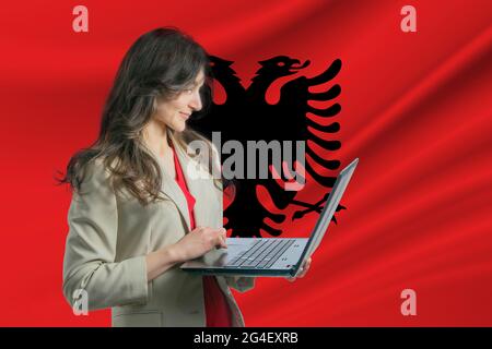 Albania national flag background with workspace, desktop computer and  office accessories on white modern table Stock Photo - Alamy