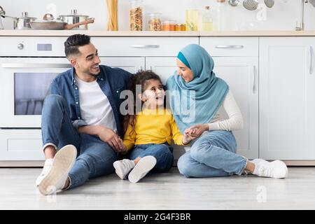 Happy Arabic Family Of three Bonding Together At Home Stock Photo