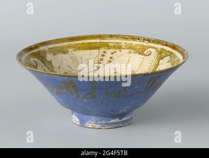 . Come from quartz frying goods decorated with inscription and stylized birds on the inner wall and bottom in luster on the surface of white enamel on the inside and from blue enamel on the outside. Stock Photo
