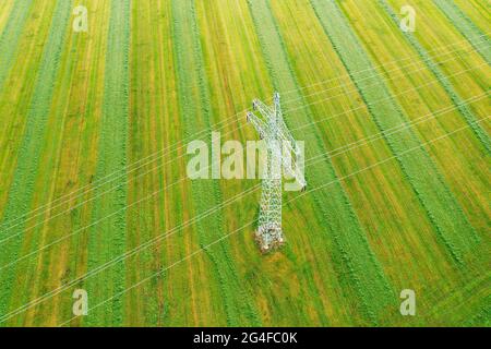 High voltage pylon, power line on green field near Dietramszell, Toelzer Land, drone image, Upper Bavaria, Bavaria, Germany Stock Photo