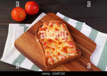 Fresh baked delectable homemade pizza toast on kitchen's table Stock Photo