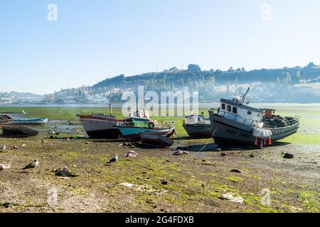 CASTRO, CHILE - MARCH 23, 2015: Fishing boats during low tide in Castro, Chiloe island, Chile Stock Photo