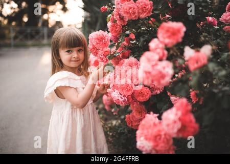 Cute kid girl 3-4 year old wearing trendy clothes posing in