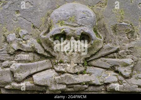 Carved skull with crossbones on the Tombstone at old Prague cemetery, Czech republic, Europe Stock Photo