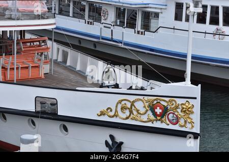 View on two moored tourist motor vessels in the harbor of city of Lucerne situated on Lake Lucerne. Ships are ready for embarkation and cruise trips. Stock Photo