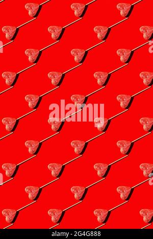 Lollipop heart shaped candy pattern, top view. Stock Photo