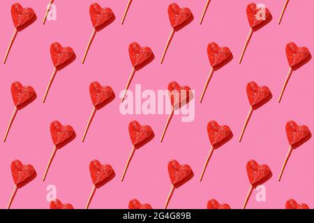 Lollipop heart shaped candy pattern, top view. Stock Photo