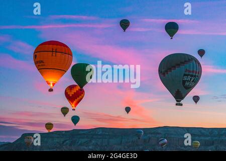 Cappadocia,October 05,2018: Tourists come to watch Hot Air Balloons flying early morning against colourful sky at Cappadocia, Goreme,Turkey Stock Photo