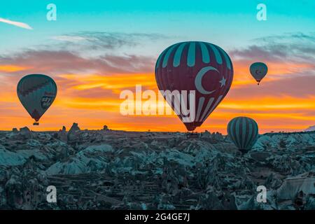 Cappadocia,October 05,2018: Tourists come to watch Hot Air Balloons flying early morning against colourful sky at Cappadocia, Goreme, Turkey Stock Photo