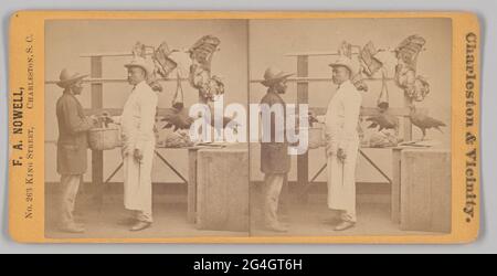 A reddish brown stereograph photograph of a butcher shop scene. In the image, two African-American men stand in front of a display of meat that appears to be staged in a photography studio. The man on the left is wearing khakis, a coat, and a hat with an up-turned rear brim. He is holding a wicker basket to the man in front of him. The man standing in the center of the image is dressed in white pants, a long-sleeved white shirt covered, white apron and a white hat. He is reaching out for the basket with one hand. In the background is a shelf with three rafters that feature two sets of ribs, an Stock Photo
