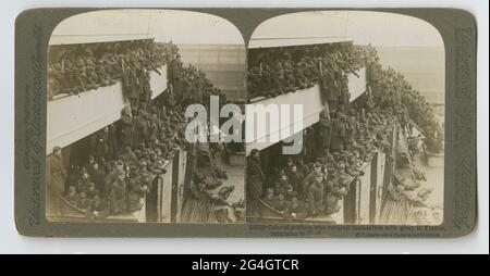 An undated sterograph of a WW1 scene captioned: &quot;Colored Soldiers who covered themselves with glory in France, returning to US&quot; No. 14338 published by Underwood &amp; Underwood. The image is of a multi-tiered ship deck crowded with soldiers in uniform. Some soldiers stand on ladders going from one level to the other. Stock Photo